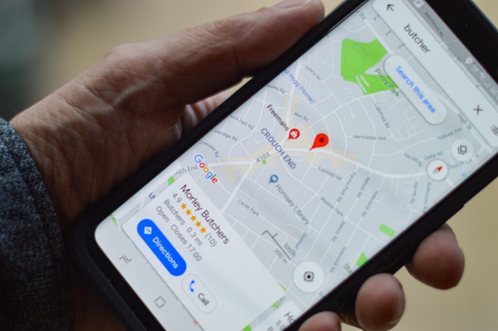 Hand holding a smartphone displaying Google Maps with a local business listing and star ratings — local SEO for small businesses